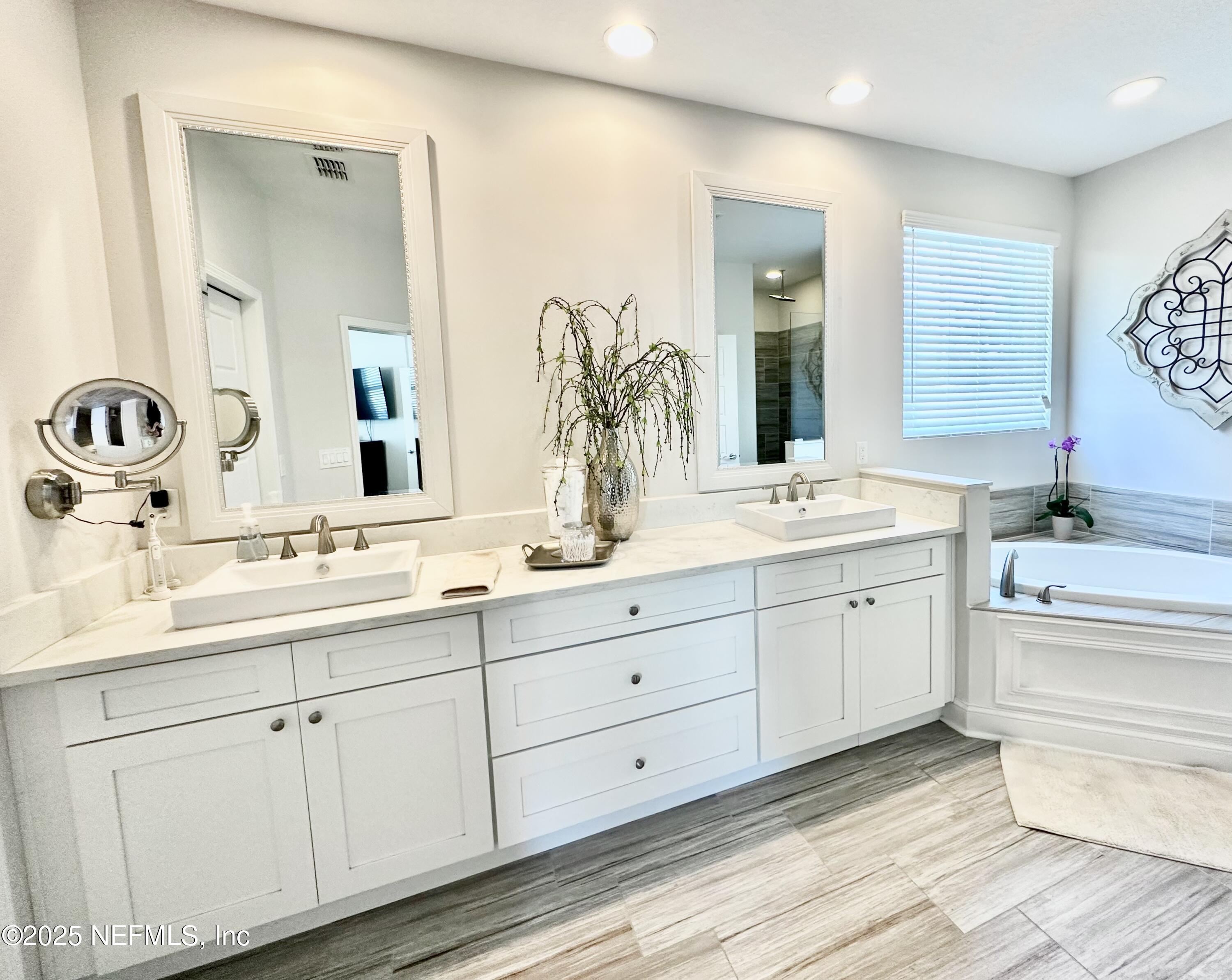 55370 Deer Run Road Callahan, FL 32011 - Photo 18 of 44 a bathroom with double sink and a mirror