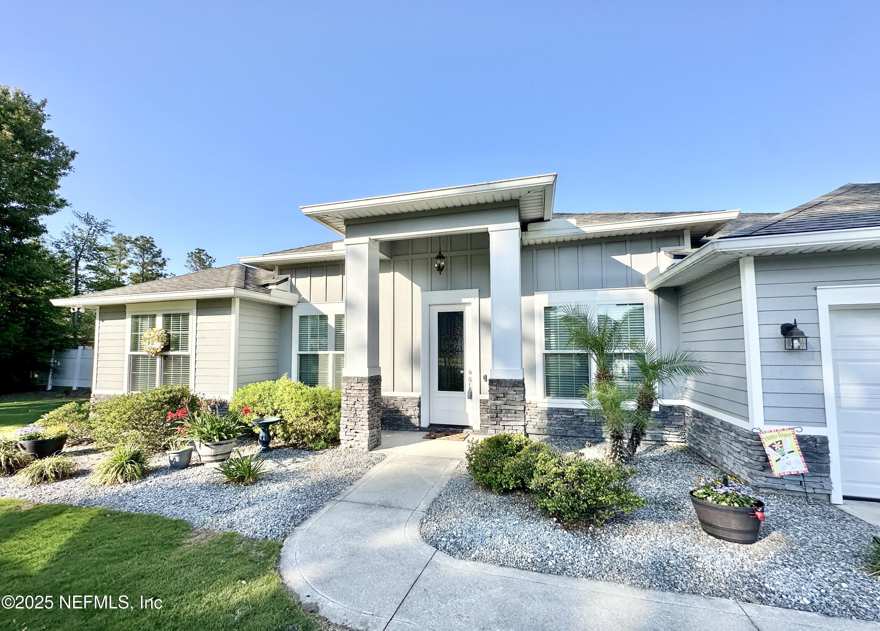 55370 Deer Run Road Callahan, FL 32011 - Photo 2 of 44 a front view of a house with garden
