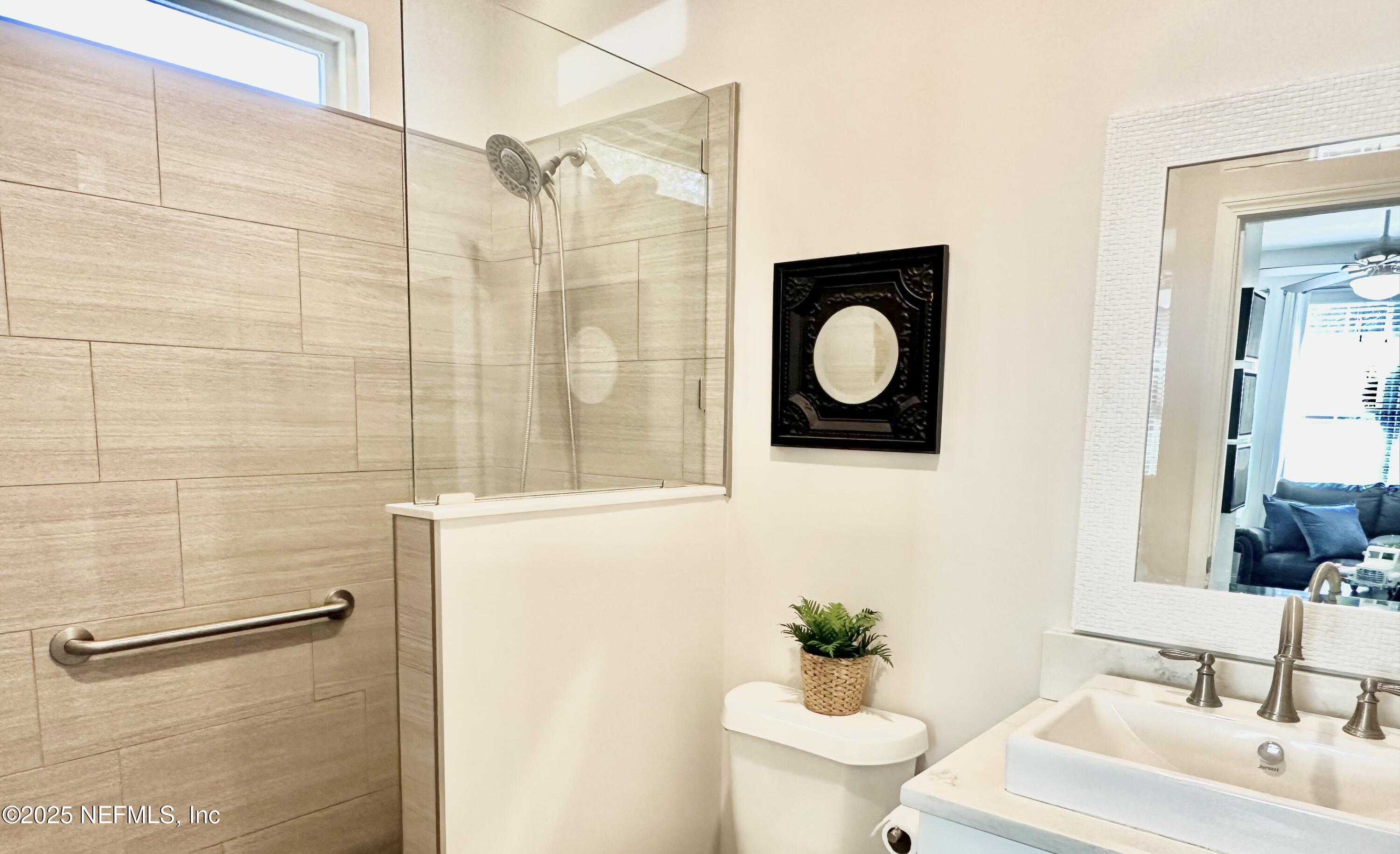 55370 Deer Run Road Callahan, FL 32011 - Photo 22 of 44 a bathroom with a toilet sink and mirror