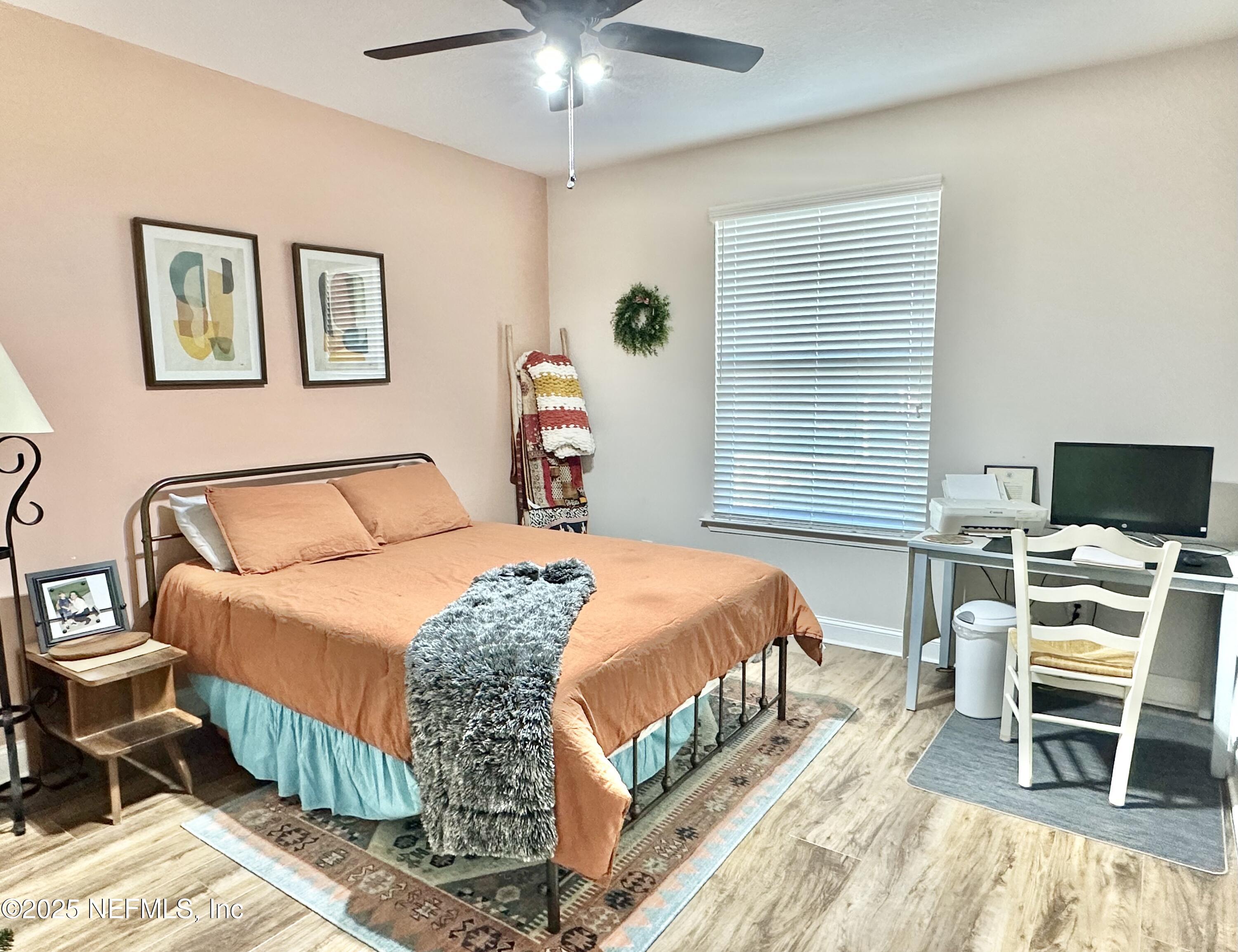 55370 Deer Run Road Callahan, FL 32011 - Photo 23 of 44 a bedroom with a bed and a flat screen tv