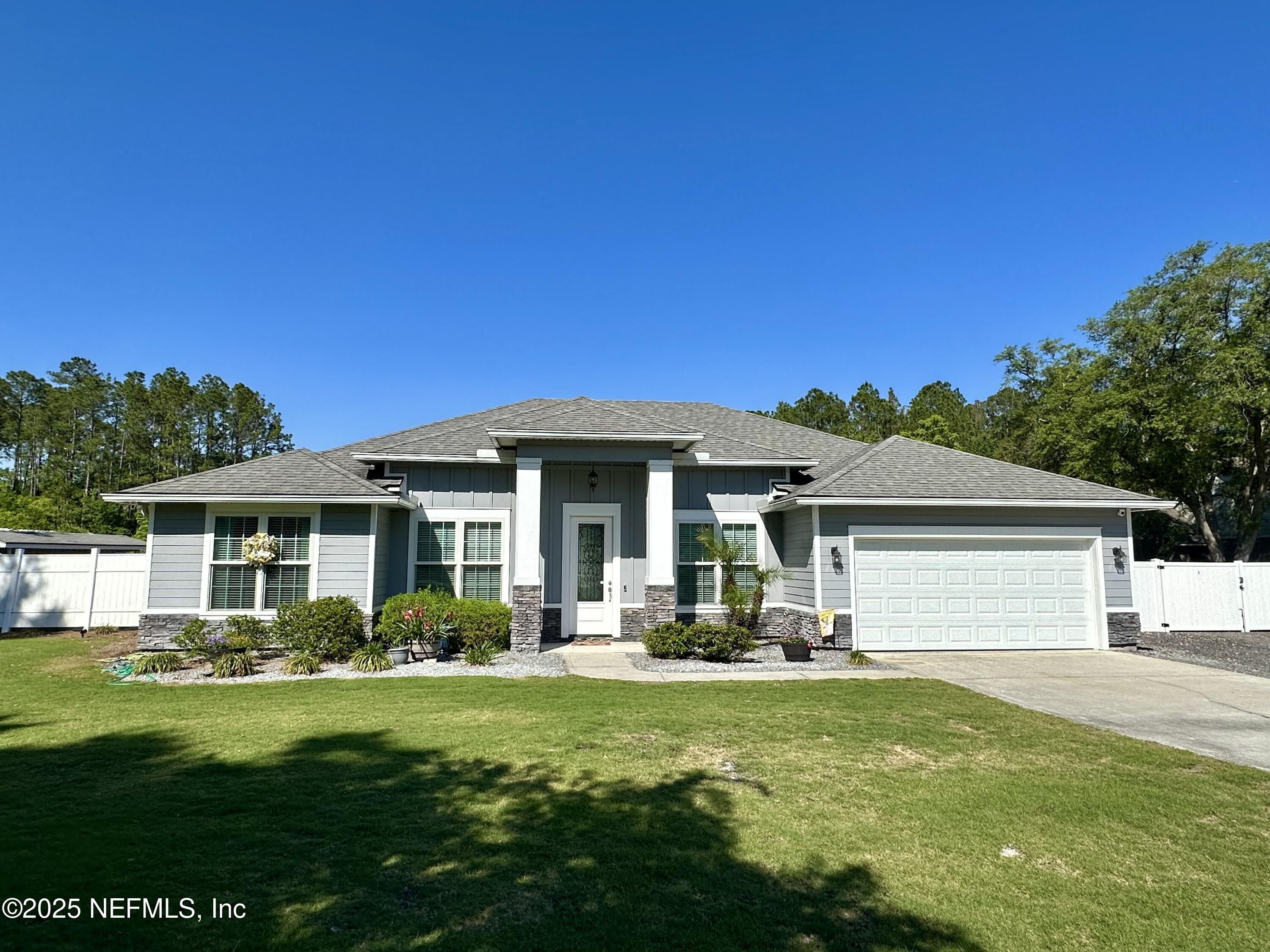 55370 Deer Run Road Callahan, FL 32011 - Photo 3 of 44 a front view of a house with a yard