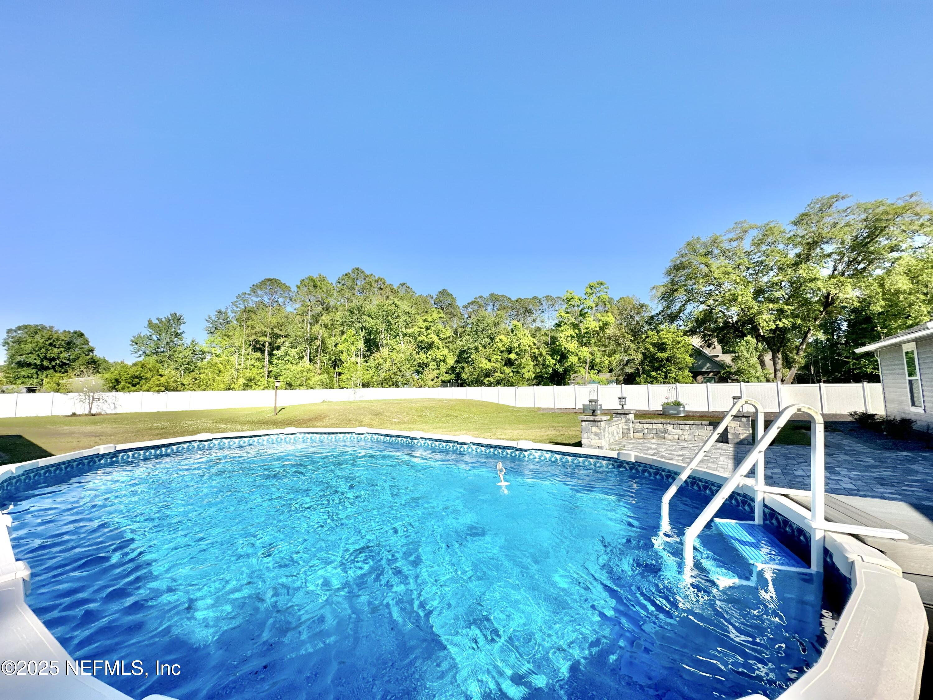 55370 Deer Run Road Callahan, FL 32011 - Photo 32 of 44 a view of a swimming pool with an outdoor space and seating area