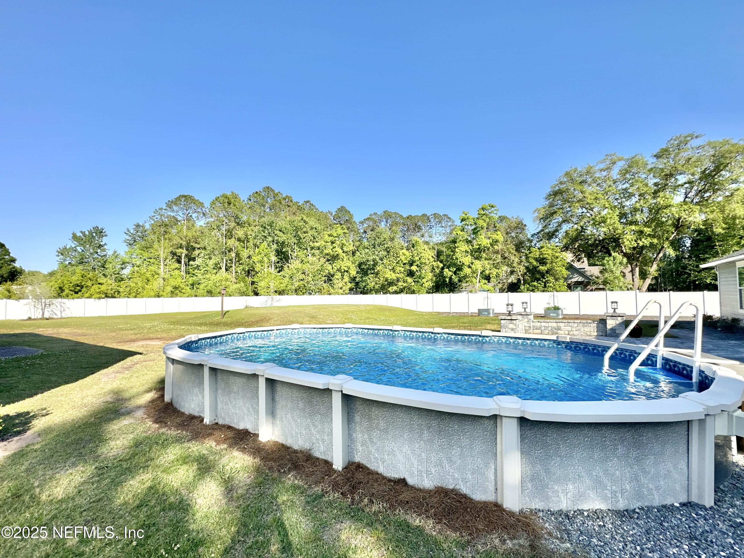 55370 Deer Run Road Callahan, FL 32011 - Photo 33 of 44 a view of a swimming pool with a yard