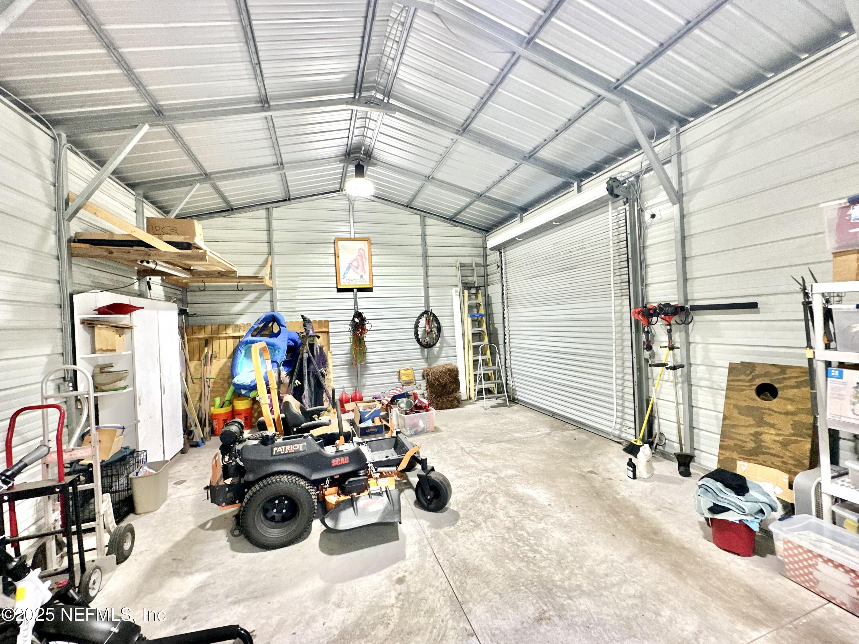 55370 Deer Run Road Callahan, FL 32011 - Photo 40 of 44 a view of a garage with rack and bicycle