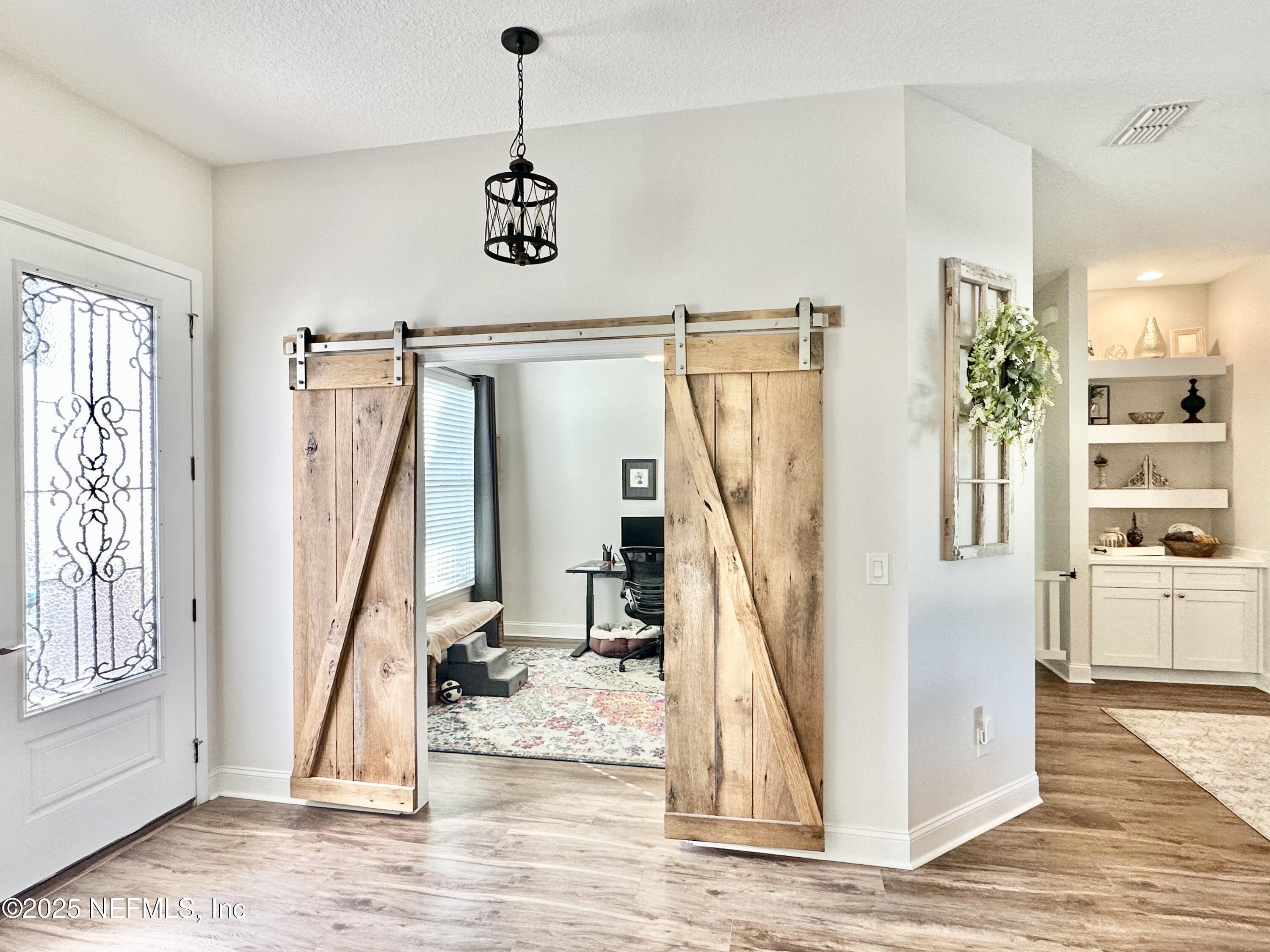 55370 Deer Run Road Callahan, FL 32011 - Photo 6 of 44 a view of a livingroom with wooden floor and windows