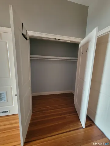 a view of walk in closet with empty racks