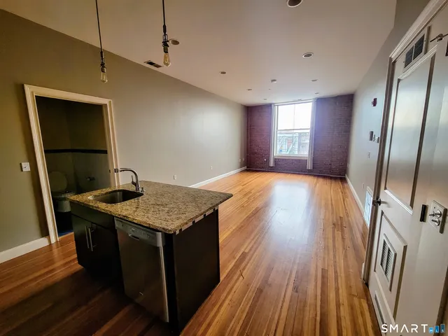 a kitchen with kitchen island a sink stove and refrigerator