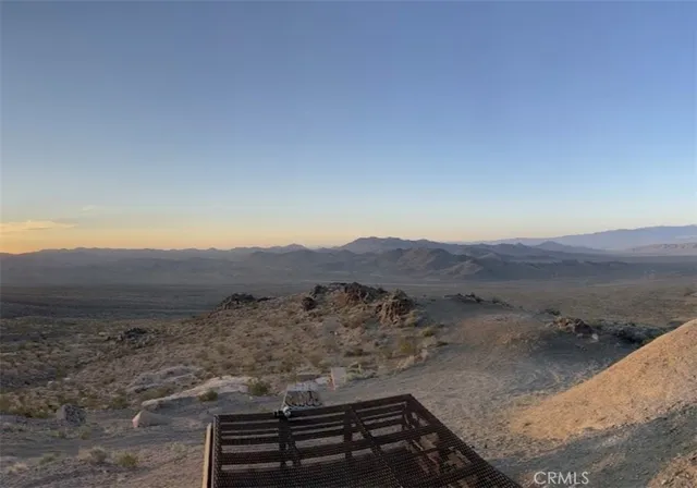 a view of a dry yard with mountain view