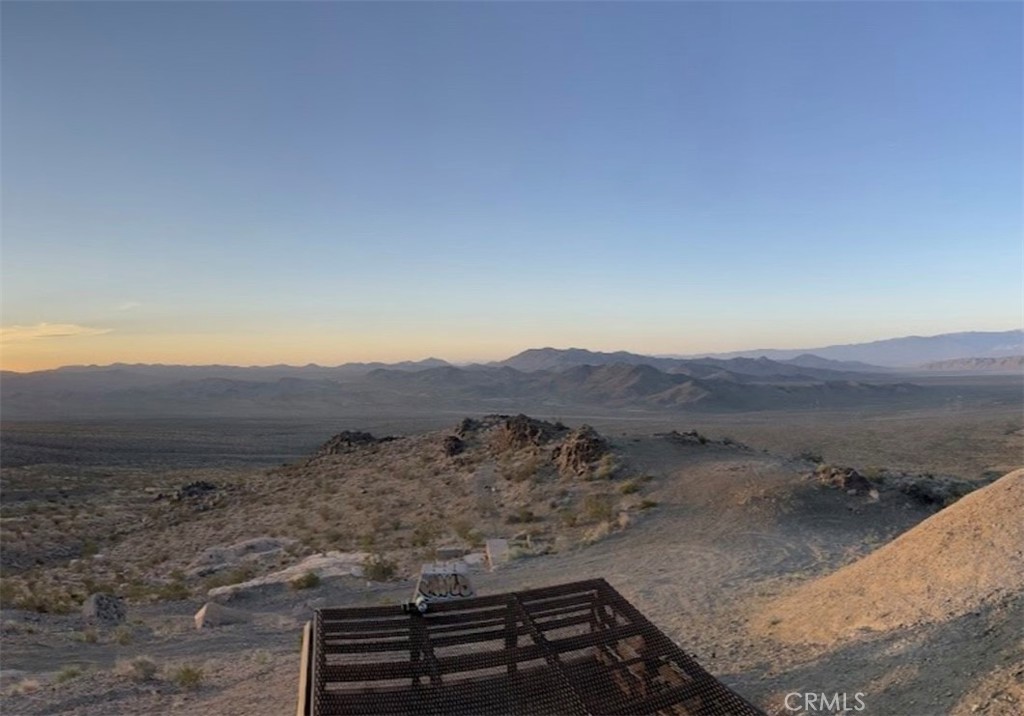 a view of a dry yard with mountain view