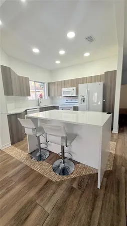 a kitchen with stainless steel appliances a refrigerator sink and cabinets