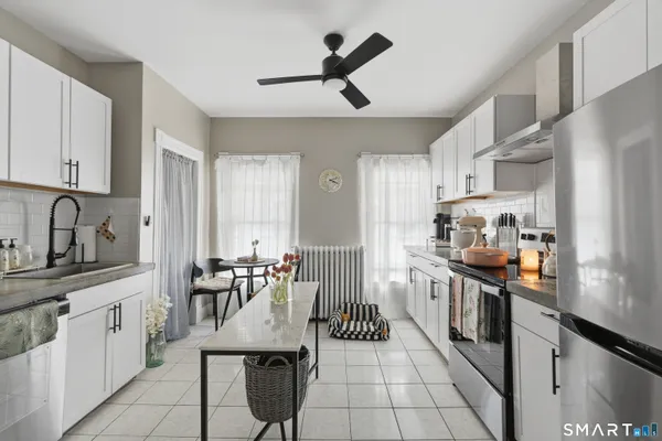 a kitchen with stainless steel appliances kitchen island granite countertop a sink and cabinets