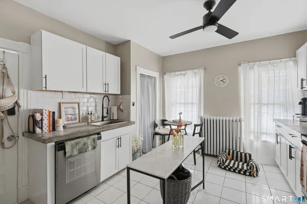 a kitchen with a sink cabinets and window