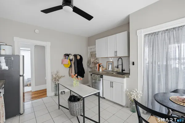 a kitchen with stainless steel appliances a stove a refrigerator and a dining table