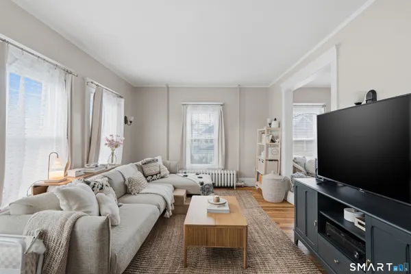a living room with furniture and a flat screen tv
