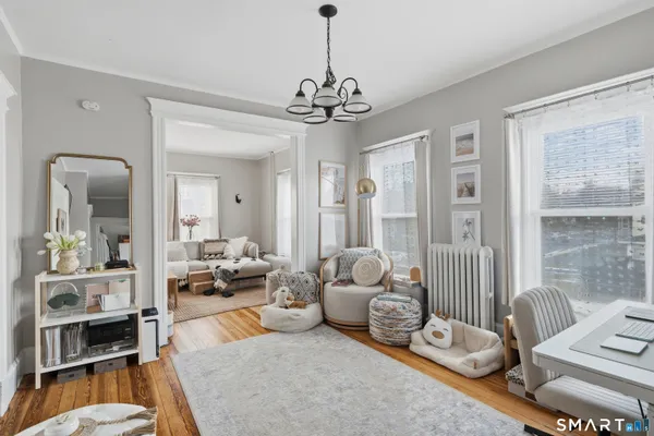a living room with furniture and a chandelier