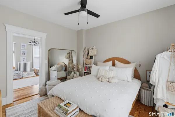 a bedroom with a bed and a mirror