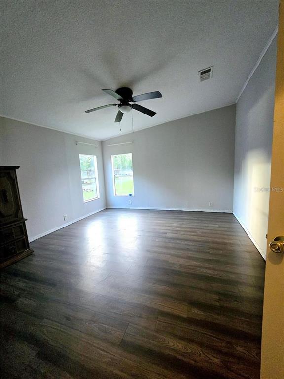 208 Pine Tree Trail Crescent City, FL 32112 - Photo 13 of 16 wooden floor in an empty room with a window