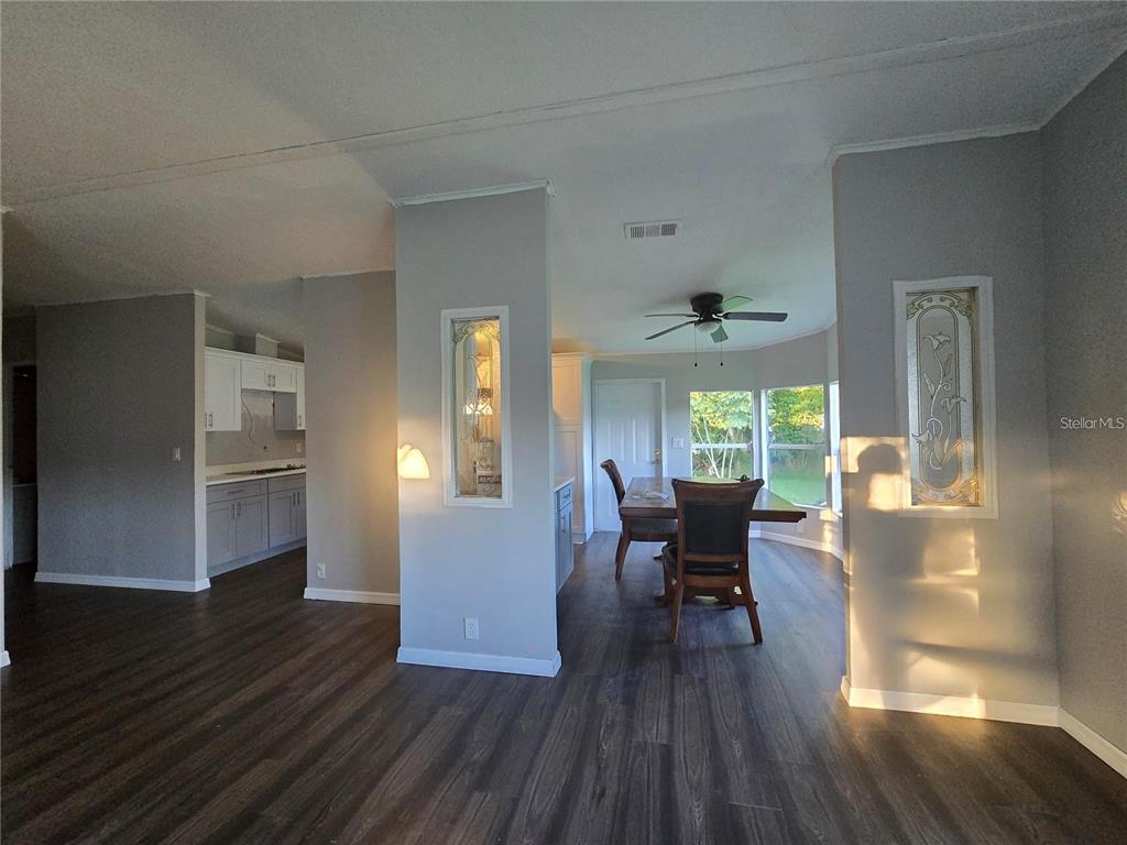 208 Pine Tree Trail Crescent City, FL 32112 - Photo 5 of 16 a view of a dining room with furniture window and wooden floor