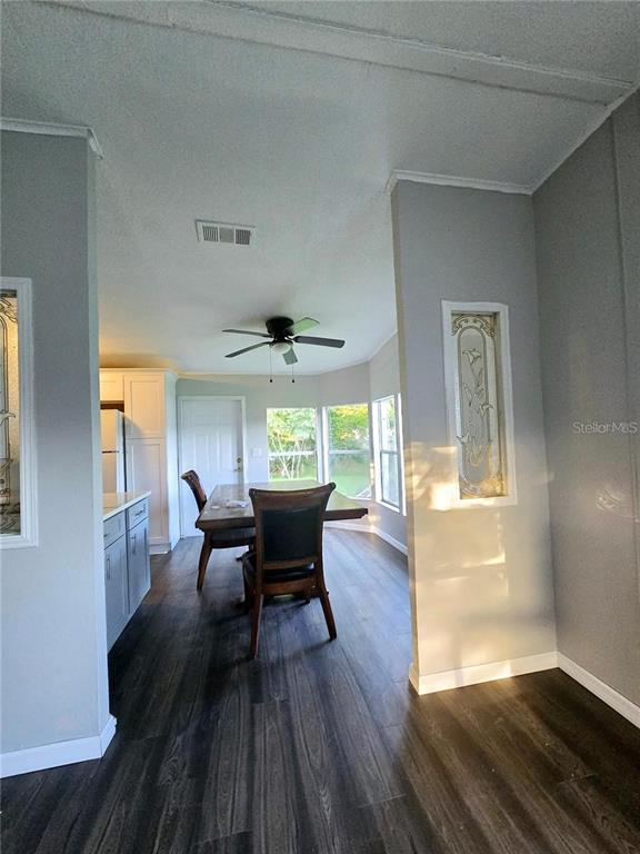 208 Pine Tree Trail Crescent City, FL 32112 - Photo 6 of 16 a view of a dining room with furniture window and wooden floor