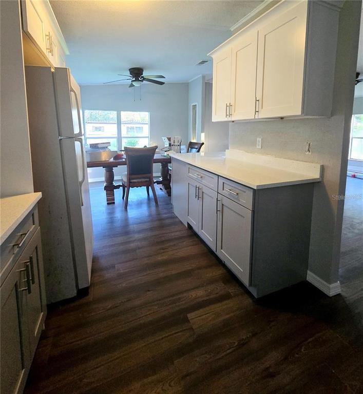 208 Pine Tree Trail Crescent City, FL 32112 - Photo 9 of 16 a kitchen with sink cabinets and wooden floor