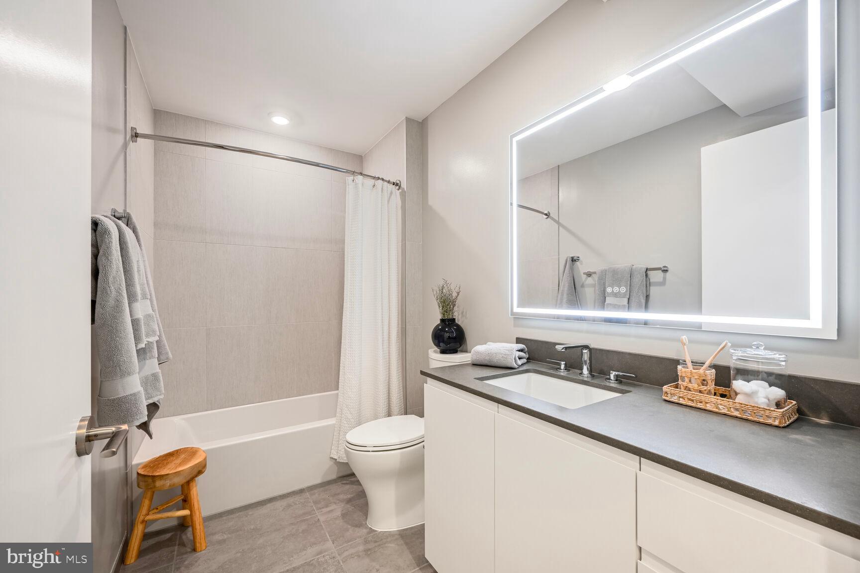 950 3rd Street Northwest, Unit 305 Washington, DC 20001 - Photo 30 of 31 a bathroom with a granite countertop sink toilet and shower