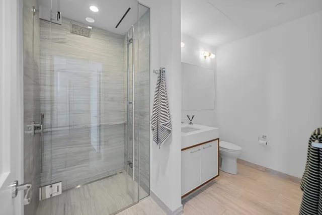 a bathroom with a double vanity sink toilet and shower