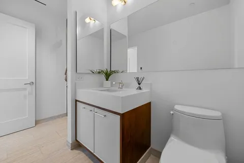 a bathroom with a sink toilet and vanity