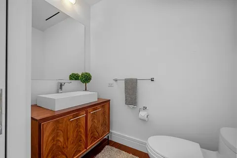 a bathroom with a sink a toilet and mirror