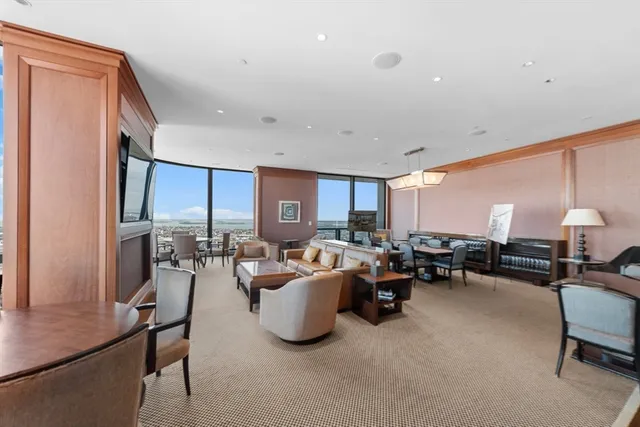 a living room with furniture a large window and a table