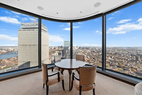 a view of a dining room with furniture and window