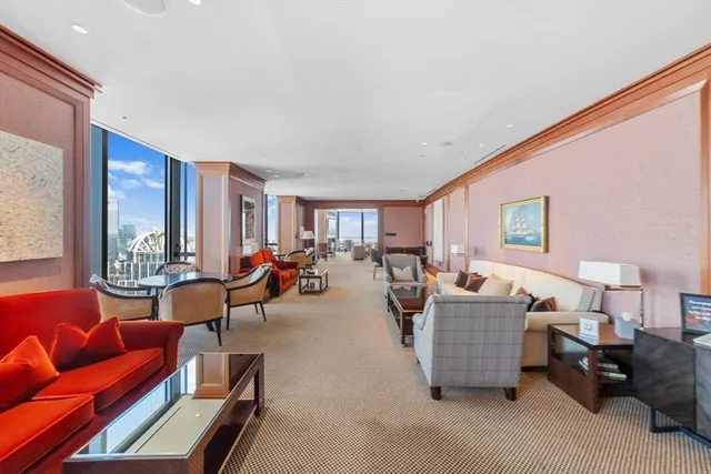 a living room with furniture and a floor to ceiling window