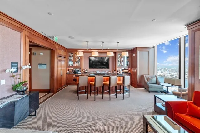 a living room with furniture a large window and a flat screen tv
