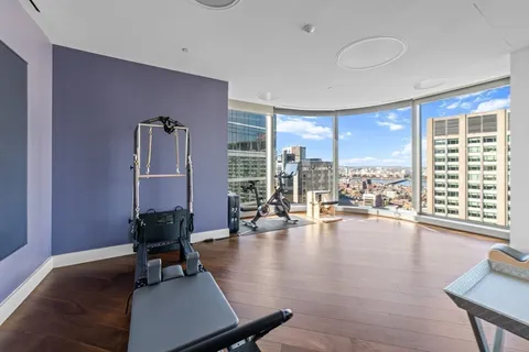 a living room with furniture and large windows
