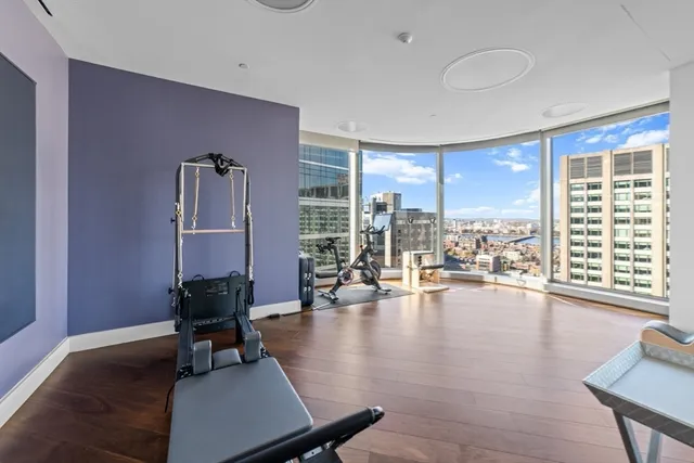 a living room with furniture and large windows