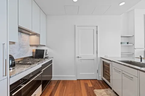 a kitchen with a sink stove and cabinets