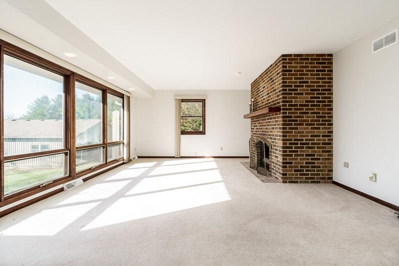 11371 Corrigan Road Roscoe, IL 61073 - Photo 11 of 85 a view of an empty room with windows