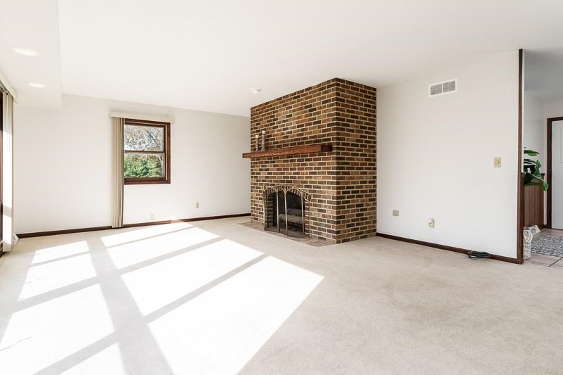 11371 Corrigan Road Roscoe, IL 61073 - Photo 12 of 85 a view of an empty room with a fireplace