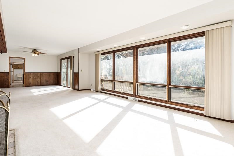 11371 Corrigan Road Roscoe, IL 61073 - Photo 14 of 85 a view of an empty room with a fireplace and a large window