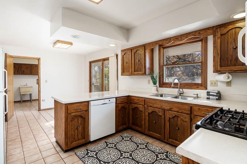 11371 Corrigan Road Roscoe, IL 61073 - Photo 17 of 85 a kitchen with a sink stove and cabinets