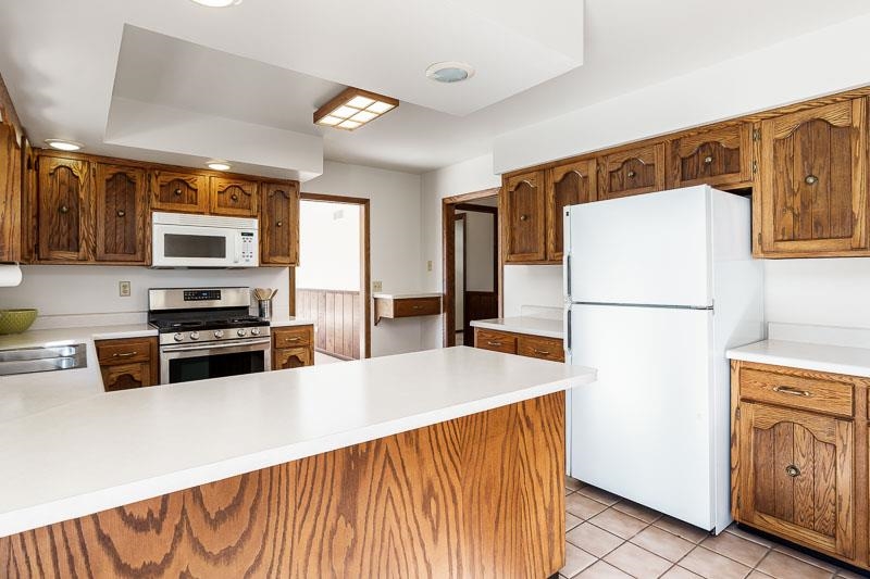 11371 Corrigan Road Roscoe, IL 61073 - Photo 22 of 85 a kitchen with stainless steel appliances a refrigerator and a stove top oven