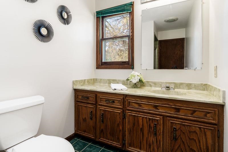 11371 Corrigan Road Roscoe, IL 61073 - Photo 28 of 85 a bathroom with a granite countertop sink mirror and toilet