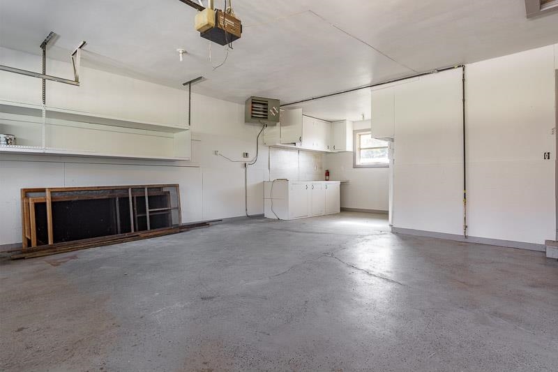 11371 Corrigan Road Roscoe, IL 61073 - Photo 60 of 85 a view of a kitchen with a sink and a fireplace