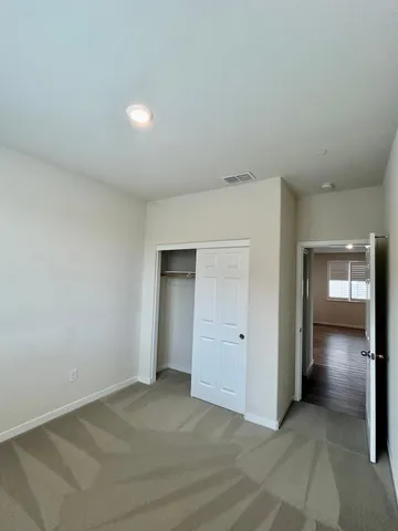 an empty room with closet and bathroom