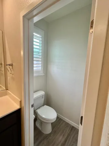 a bathroom with a toilet a sink and a window