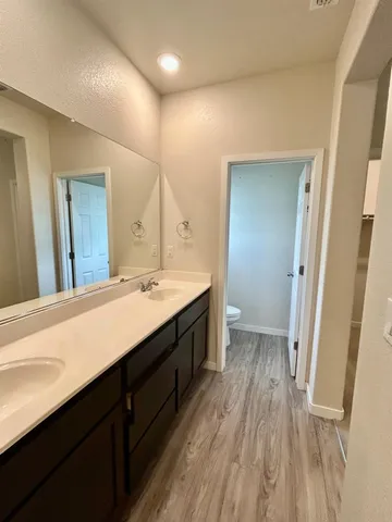a spacious bathroom with a double vanity sink and a mirror