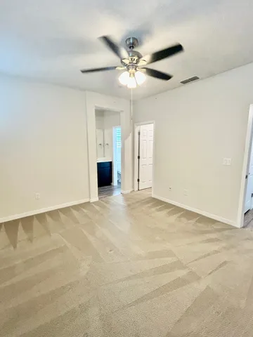 a view of a livingroom with a ceiling fan and window