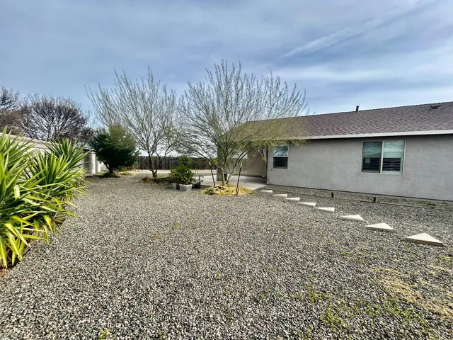a backyard of a house with table and chairs