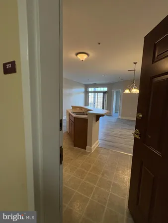 a kitchen with granite countertop a refrigerator and a sink