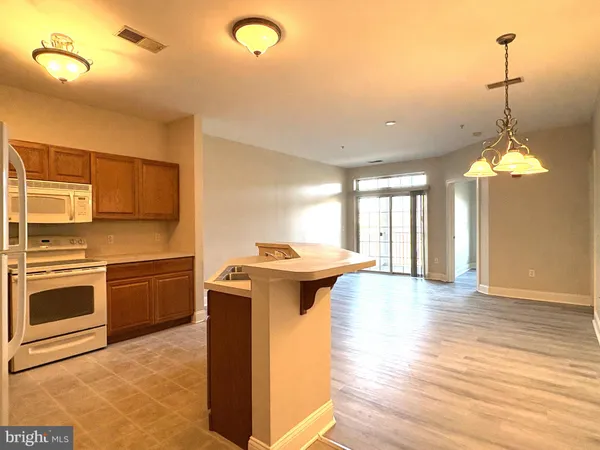 a kitchen with stove and cabinets