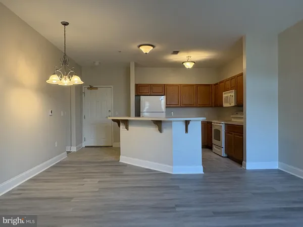 a view of a kitchen with a refrigerator and microwave